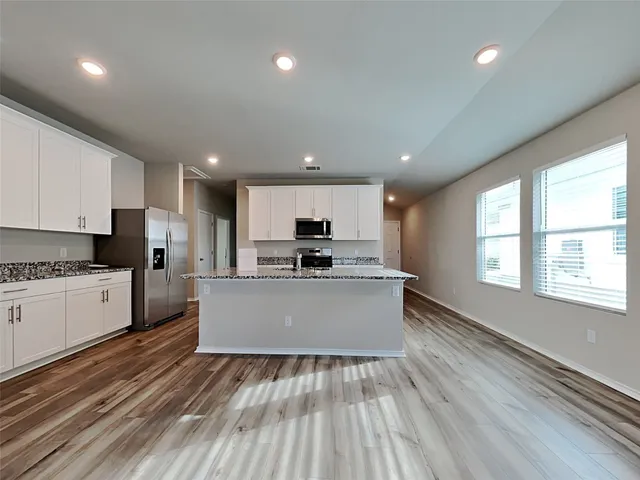 a view of kitchen with sink microwave and refrigerator
