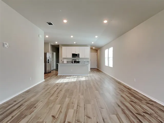 a view of a kitchen with a sink and a refrigerator
