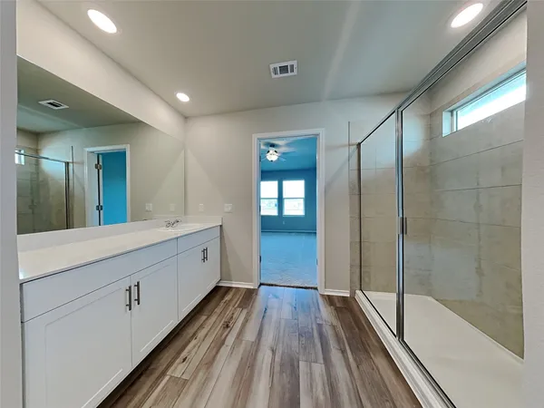 a spacious bathroom with a double vanity sink and a mirror