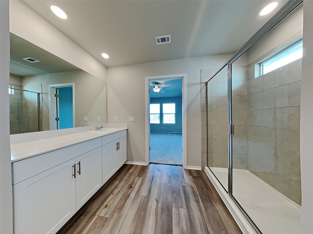 5236 Gallop Lane Georgetown, TX 78626 - Photo 8 of 13 a spacious bathroom with a double vanity sink and a mirror