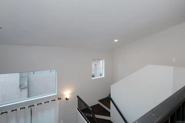 a view of room with stairs and wooden floor