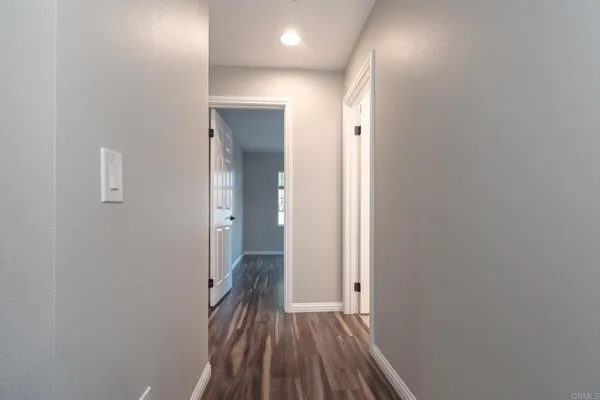 a view of hallway with wooden floor