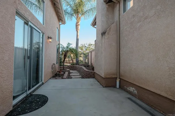 a backyard of a house with table and chairs