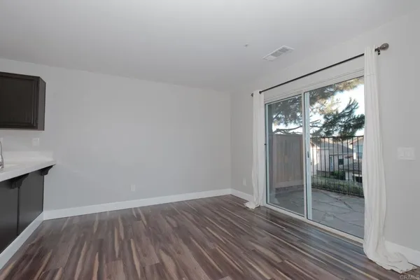a view of hallway with wooden floor and fan