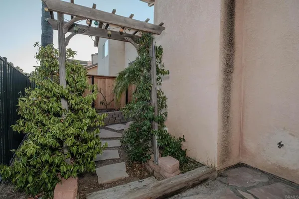 view of a pathway of a house with potted plants
