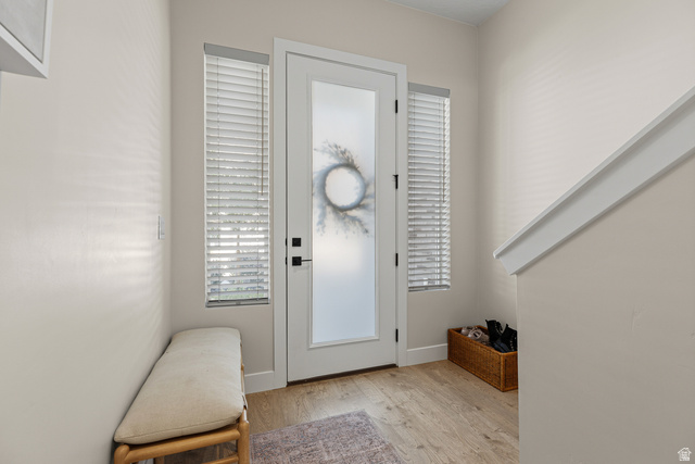 839 Walker Way St. George, UT 84770 - Photo 17 of 32 Entryway featuring wood-finish flooring, a full-lite door with frosted glass, and two sidelights with blinds