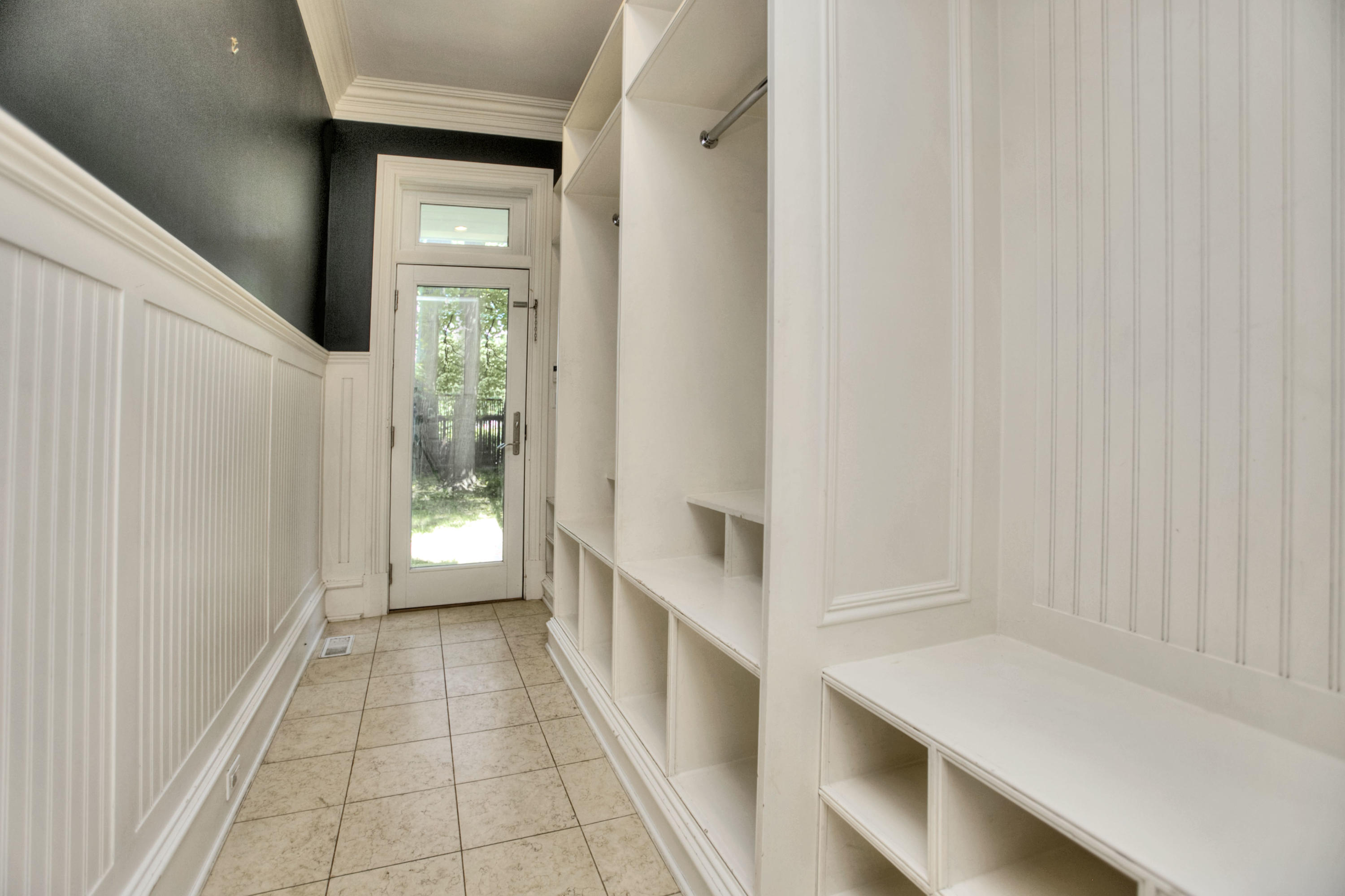 536 Roxbury Road Stamford, CT 06902 - Photo 12 of 38 a hallway with white doors wooden floor and glass door