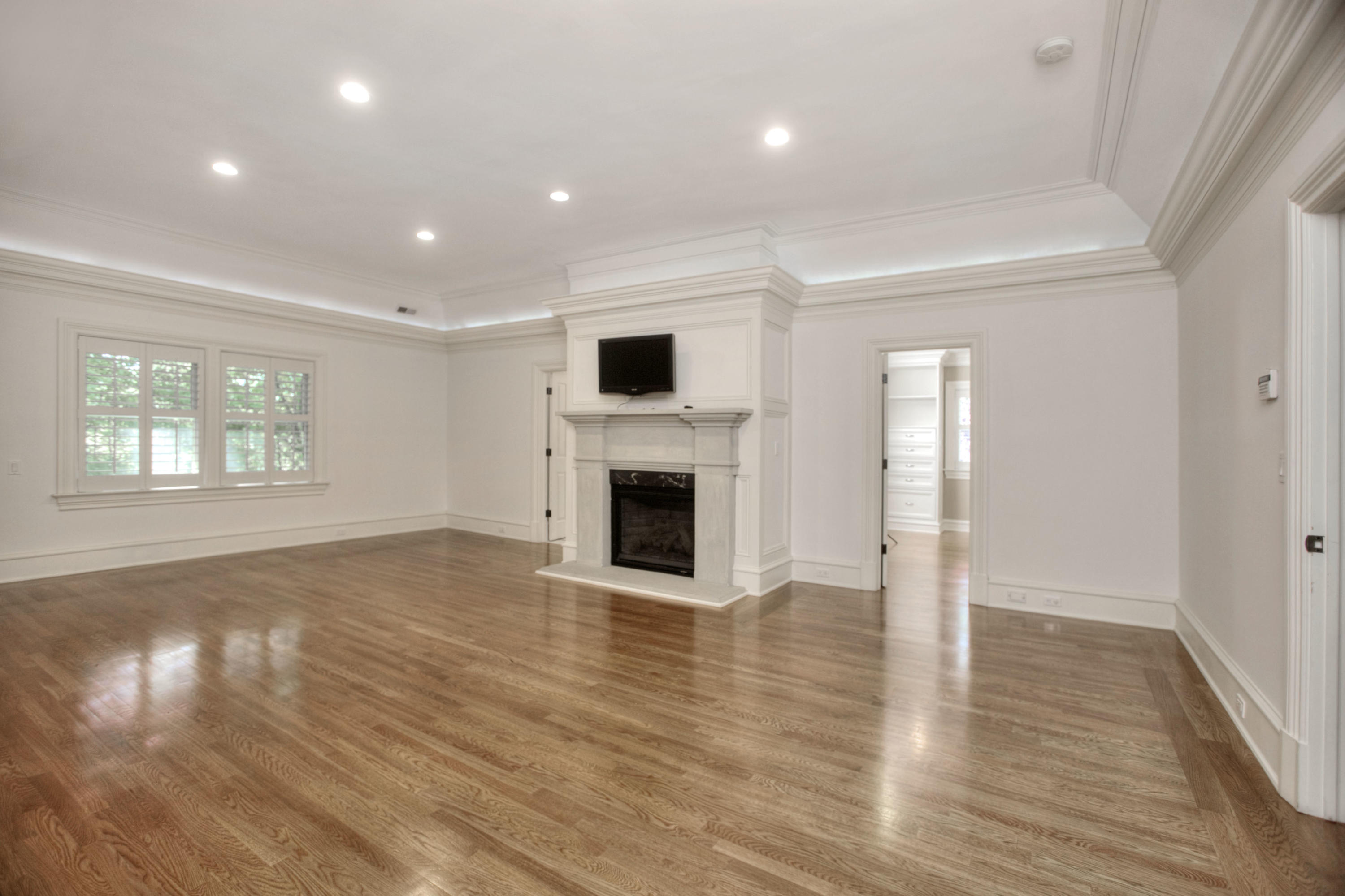 536 Roxbury Road Stamford, CT 06902 - Photo 13 of 38 an empty room with wooden floor fireplace and windows