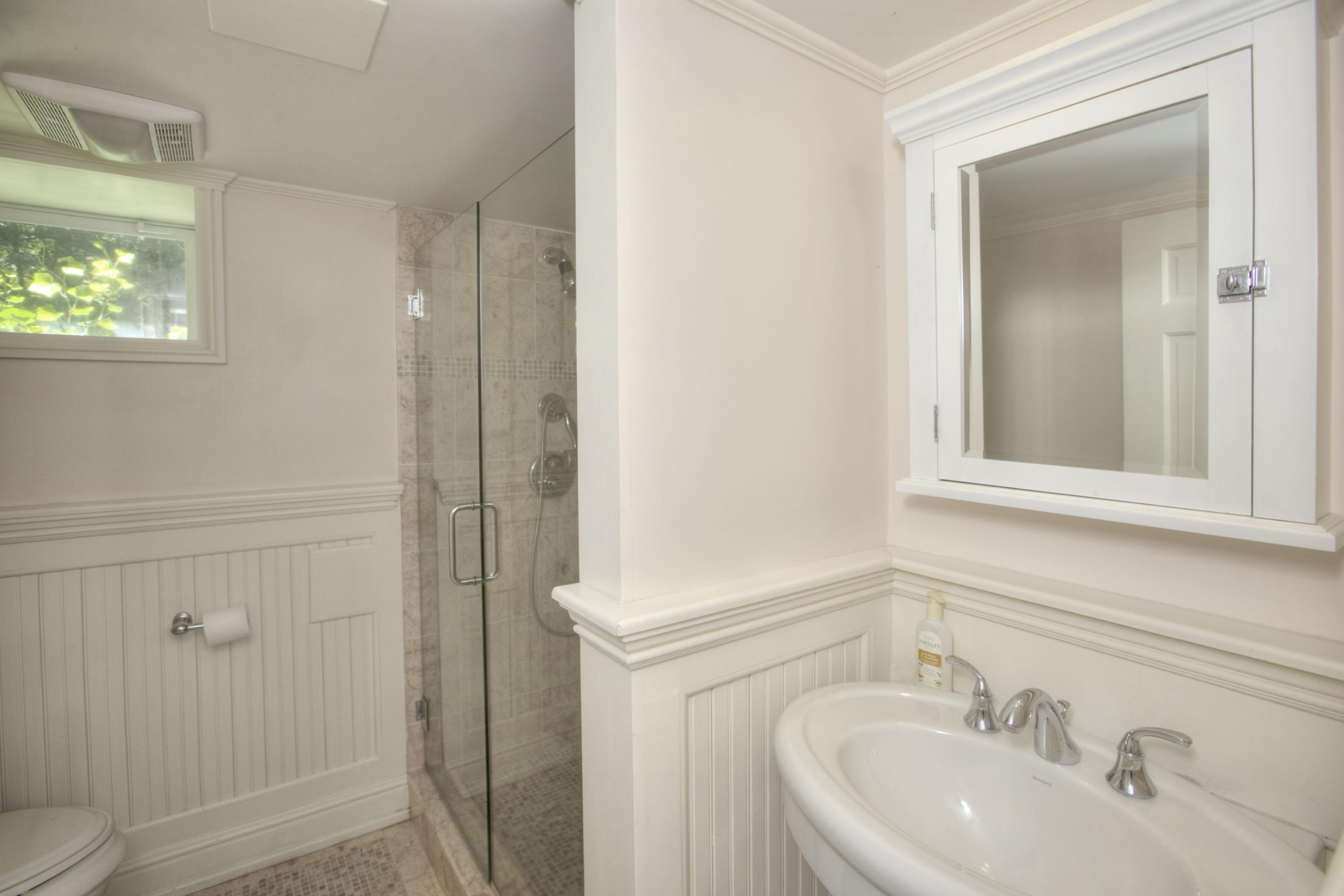536 Roxbury Road Stamford, CT 06902 - Photo 28 of 38 a bathroom with a sink and a mirror