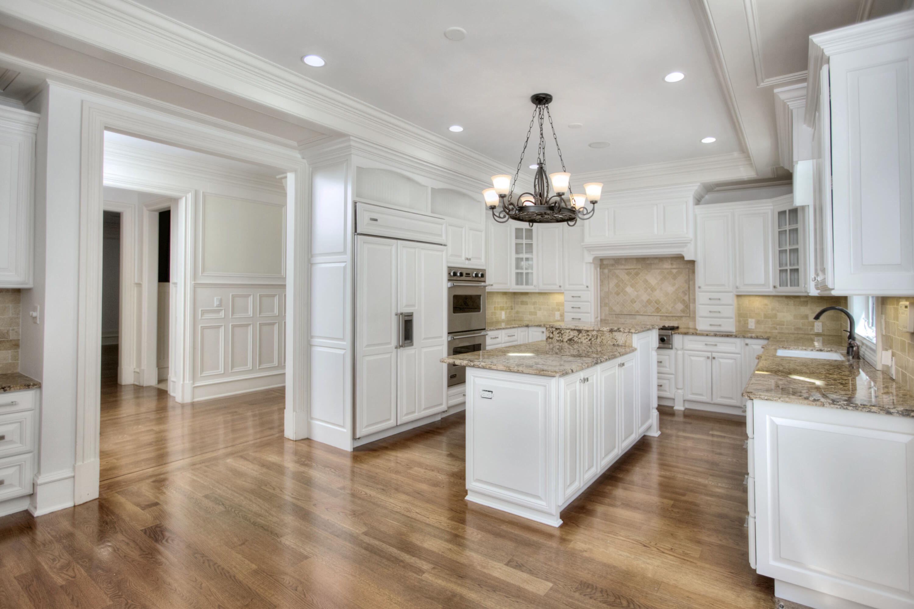 536 Roxbury Road Stamford, CT 06902 - Photo 6 of 38 a kitchen with kitchen island white cabinets and stainless steel appliances