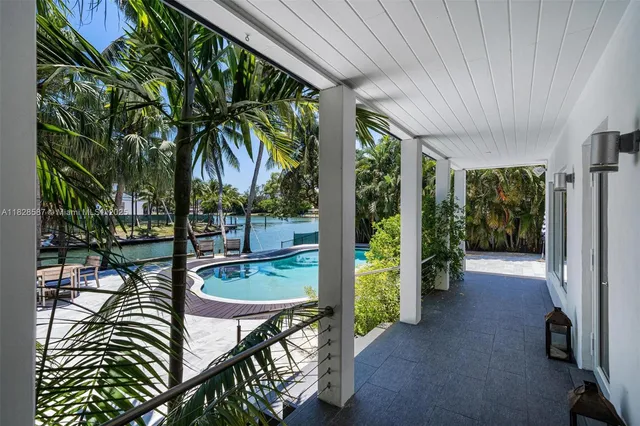 a living room with furniture and large windows