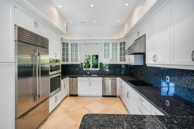 a view of swimming pool with a lounge chair and palm trees