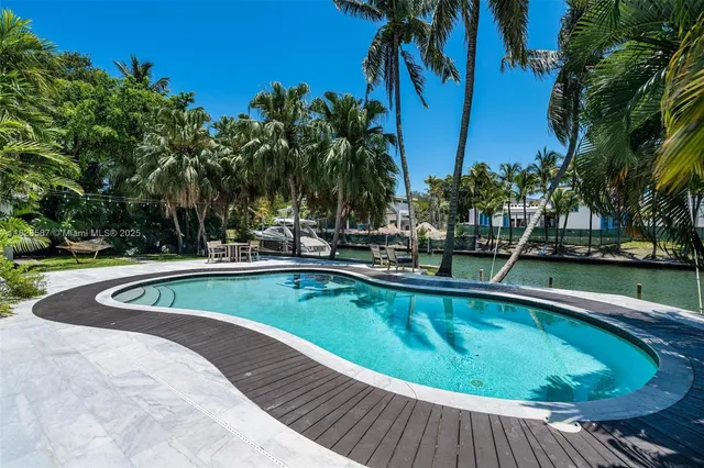a view of a lake with palm trees