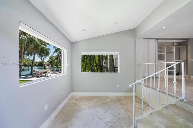 a front view of a house with a garden and trees