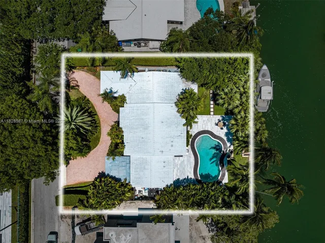 an aerial view of a house with a garden and lake view