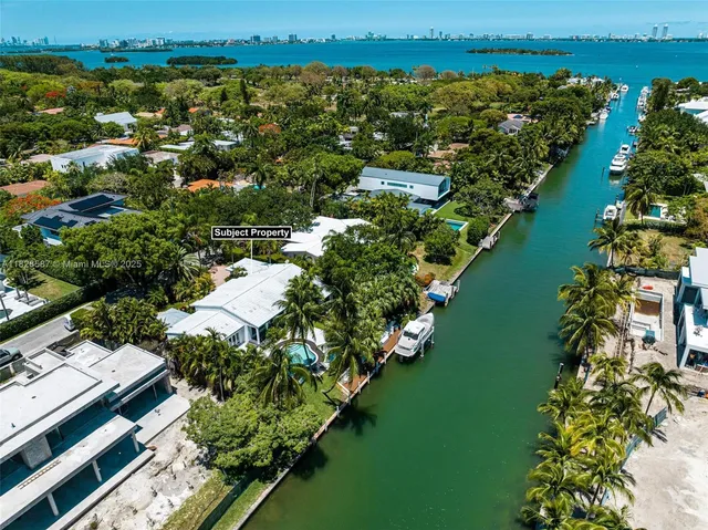 an aerial view of a city with lots of residential buildings lake and ocean view