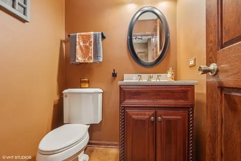 a bathroom with a toilet a sink and a mirror