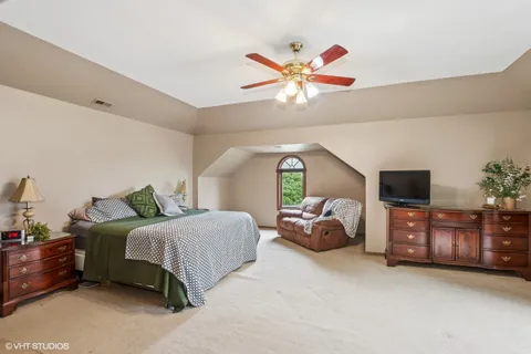 a bedroom with a bed and a chandelier