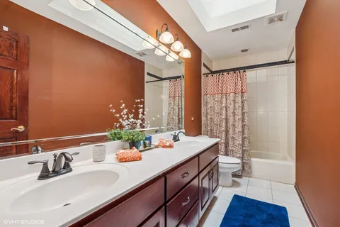 a bathroom with a double vanity sink and a mirror