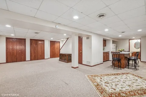 a view of a livingroom with furniture and kitchen view