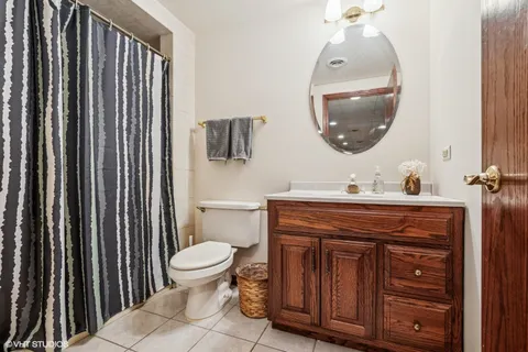a bathroom with a toilet a sink and a mirror