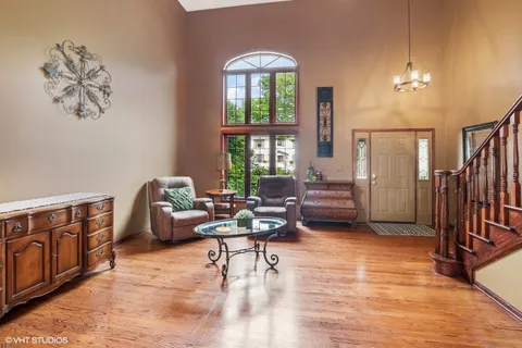 a living room with furniture a fireplace and a chandelier