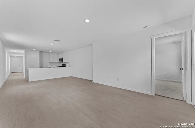 a view of a big room with closet and windows