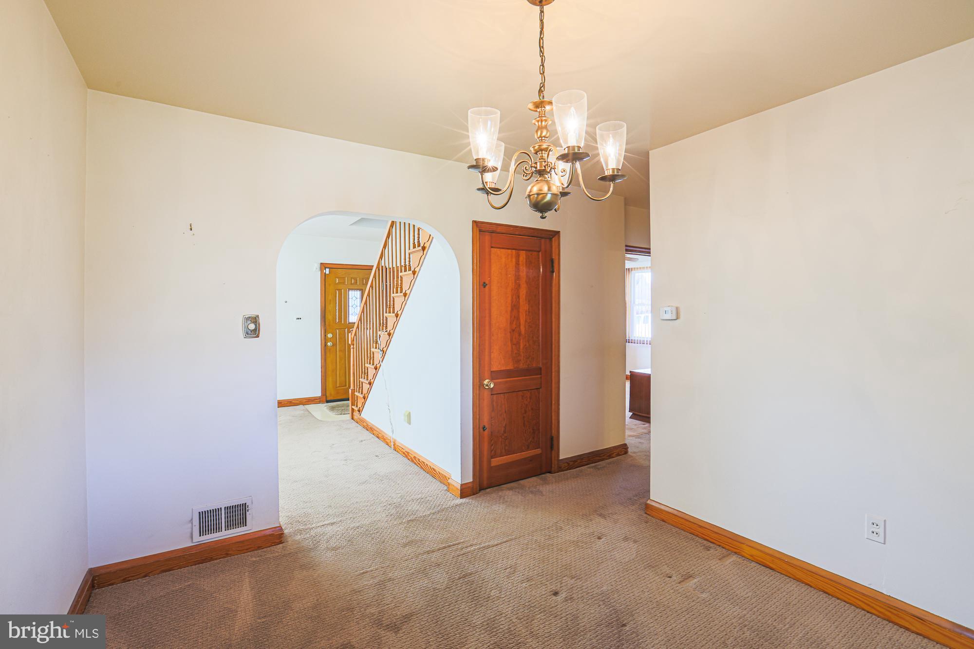 8506 Coco Road Baltimore, MD 21237 - Photo 11 of 39 a view of a hallway with a chandelier