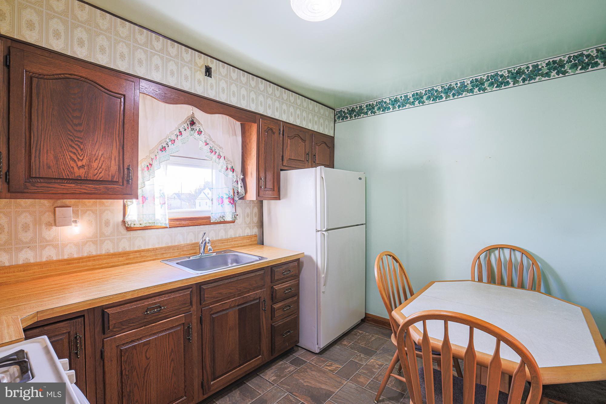 8506 Coco Road Baltimore, MD 21237 - Photo 14 of 39 a kitchen with stainless steel appliances granite countertop a sink a refrigerator and a stove