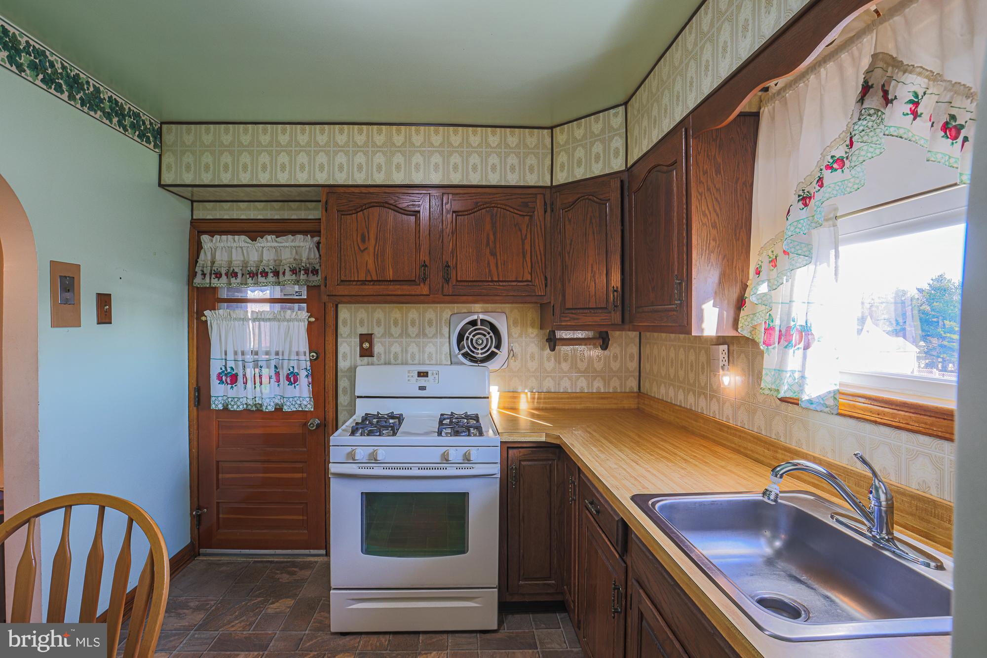 8506 Coco Road Baltimore, MD 21237 - Photo 16 of 39 a kitchen with a stove and a sink