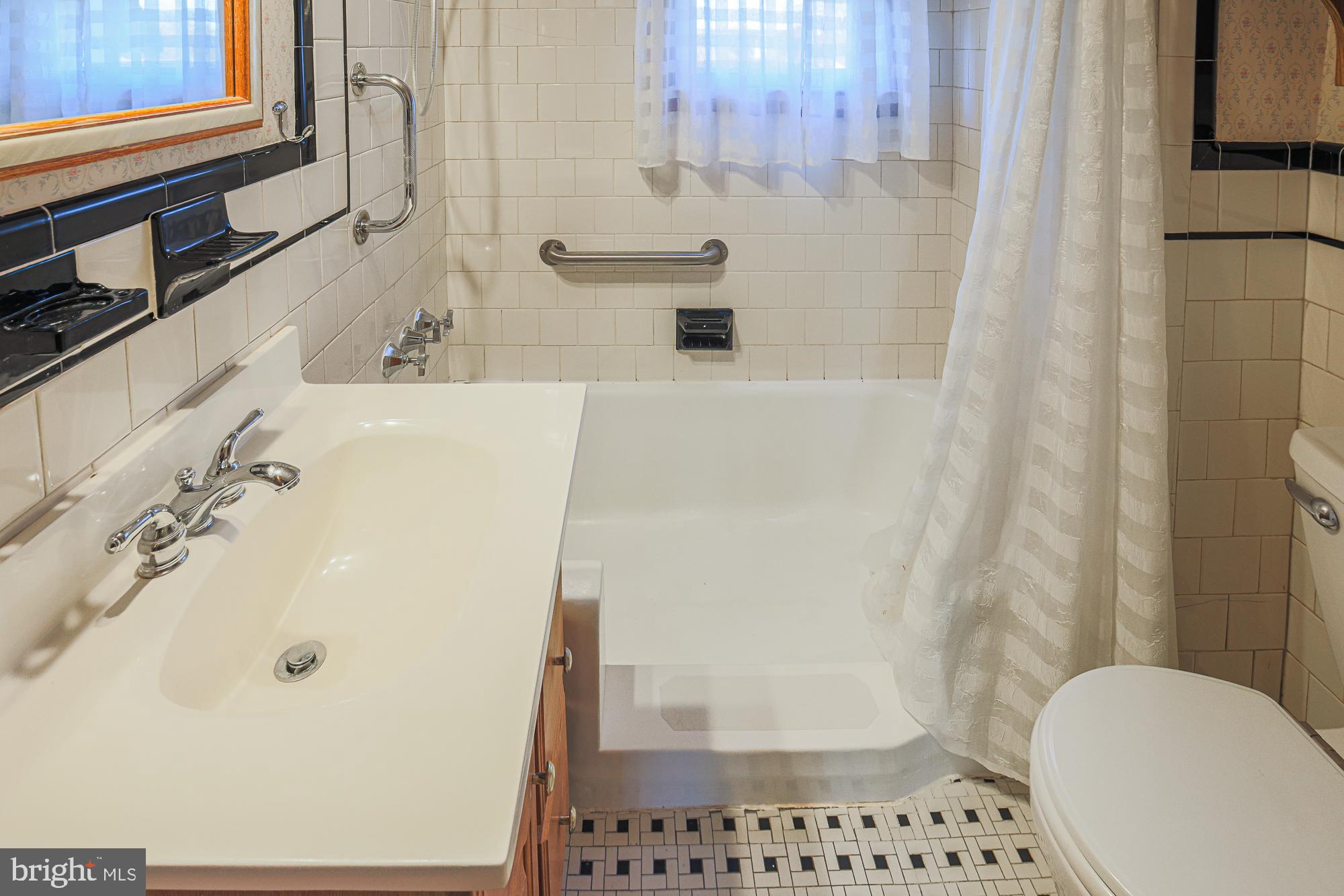 8506 Coco Road Baltimore, MD 21237 - Photo 21 of 39 a bathroom with a sink a toilet and shower