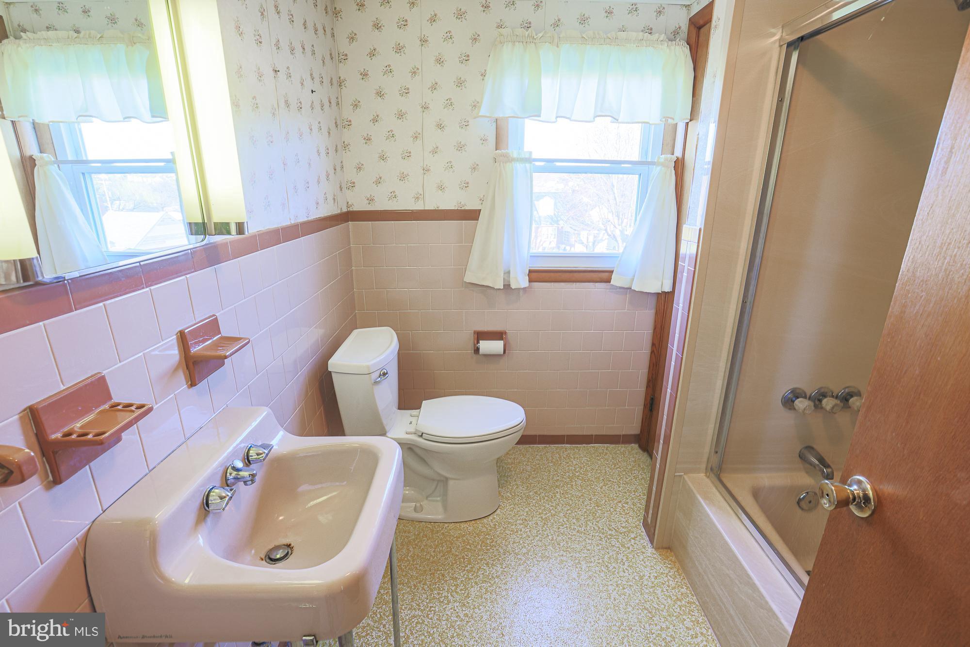 8506 Coco Road Baltimore, MD 21237 - Photo 27 of 39 a bathroom with a toilet a sink and a window