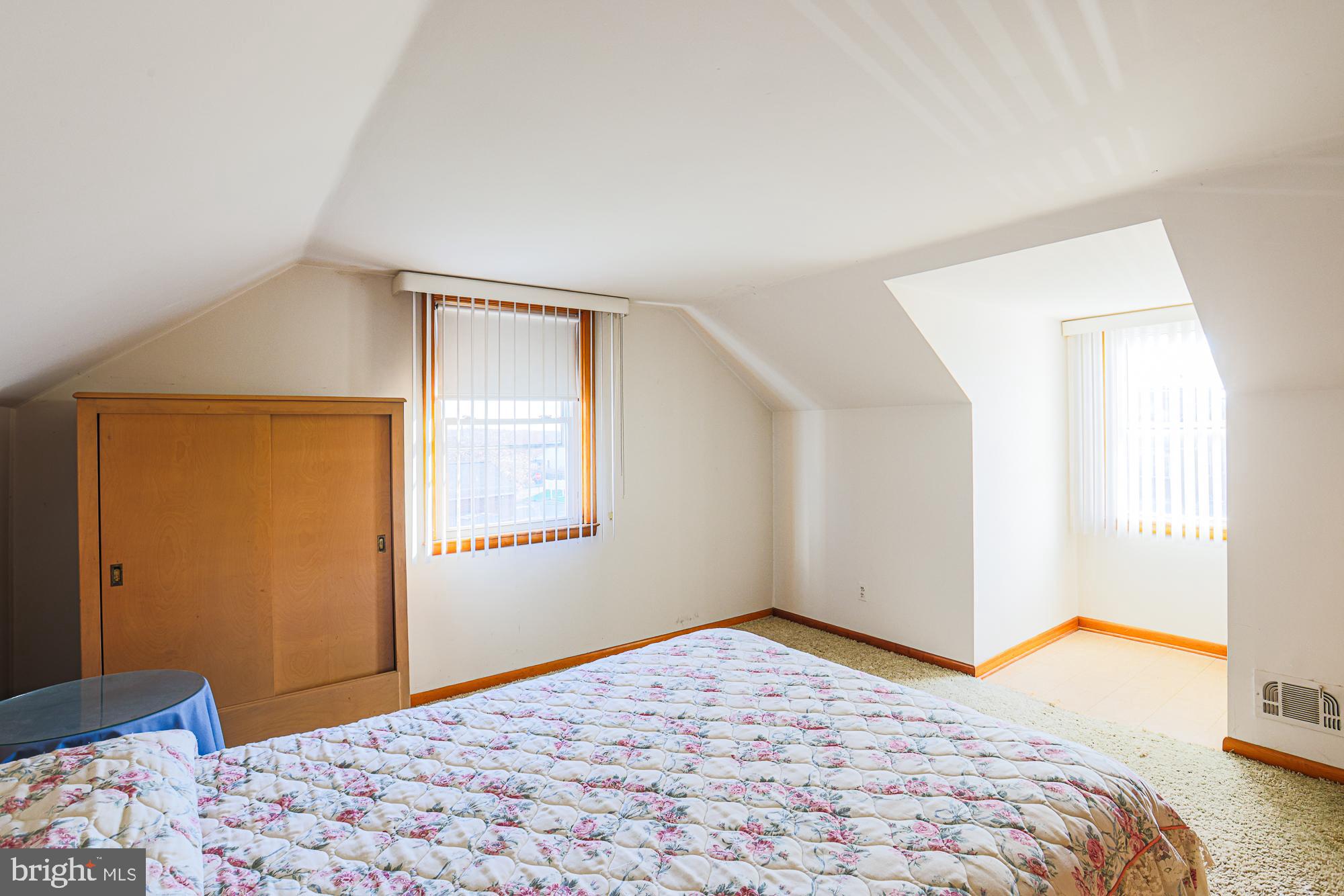 8506 Coco Road Baltimore, MD 21237 - Photo 28 of 39 a bedroom with a bed and a window in it