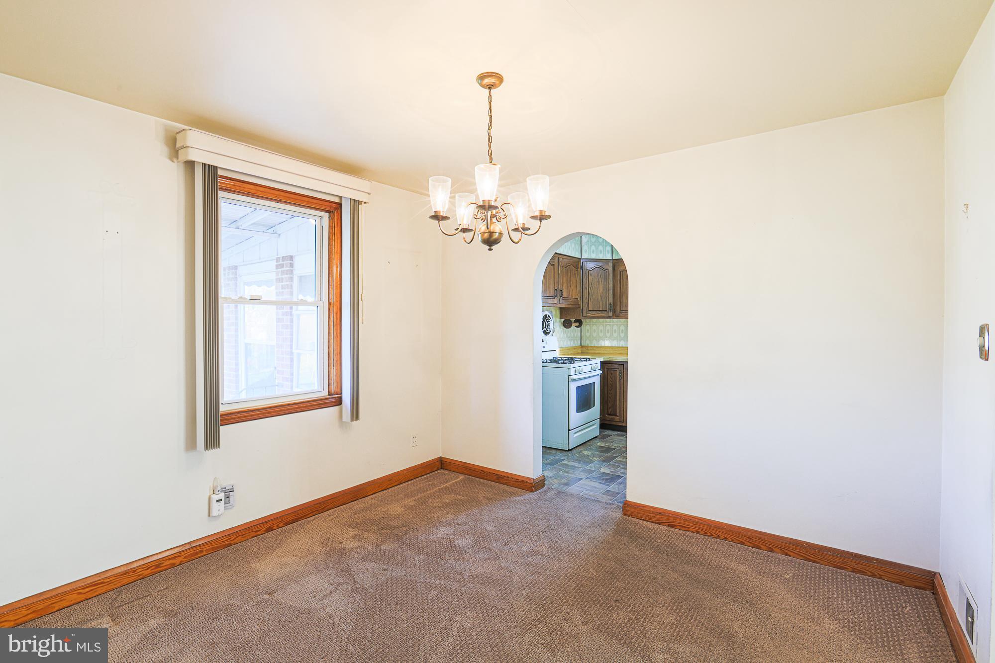 8506 Coco Road Baltimore, MD 21237 - Photo 9 of 39 an empty room with chandelier fan and windows