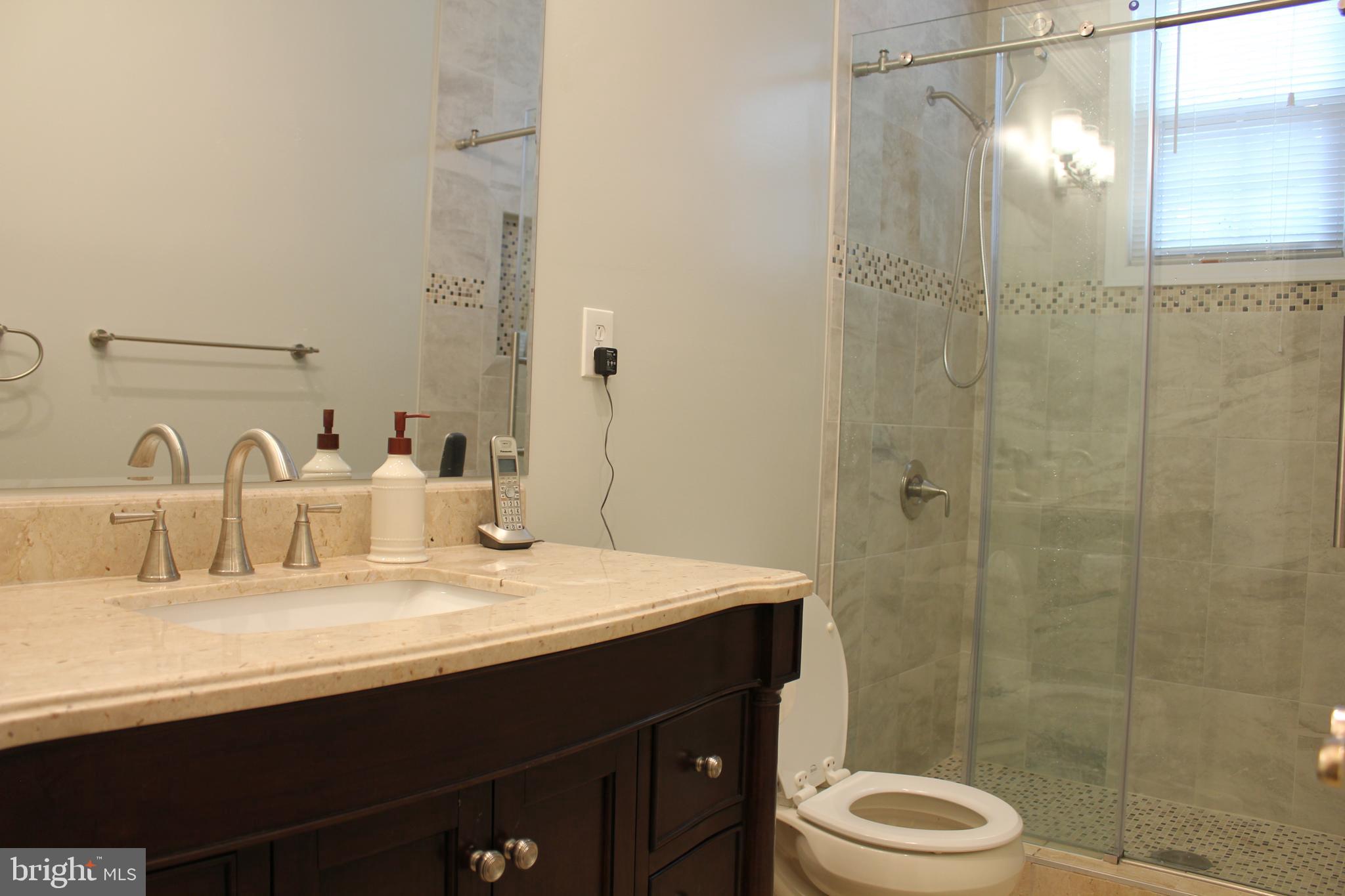 9706 Middleton Ridge Road Vienna, VA 22182 - Photo 12 of 17 a bathroom with a sink and a mirror