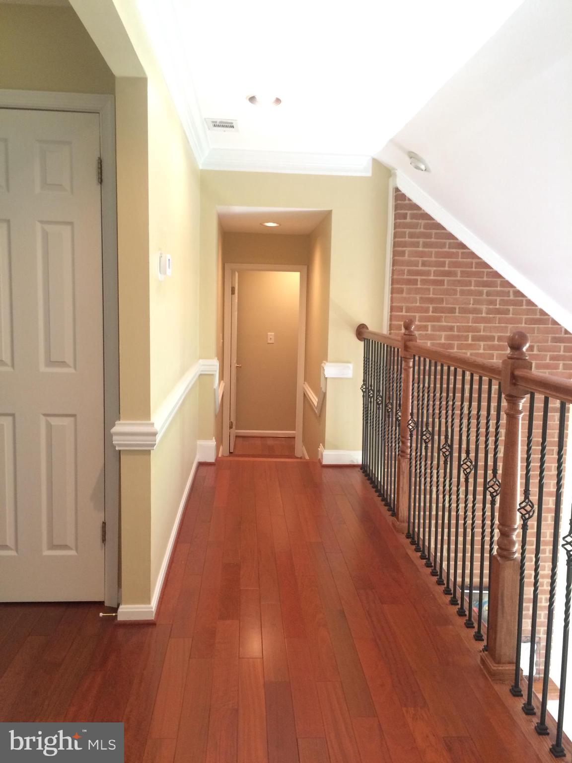 9706 Middleton Ridge Road Vienna, VA 22182 - Photo 13 of 17 a view of a hallway with wooden floor