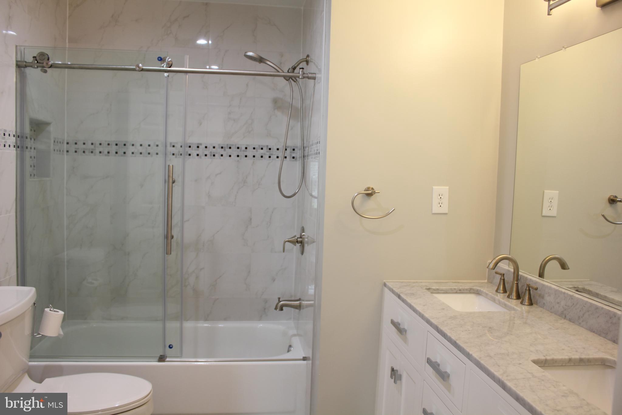 9706 Middleton Ridge Road Vienna, VA 22182 - Photo 16 of 17 a bathroom with a granite countertop sink toilet and shower