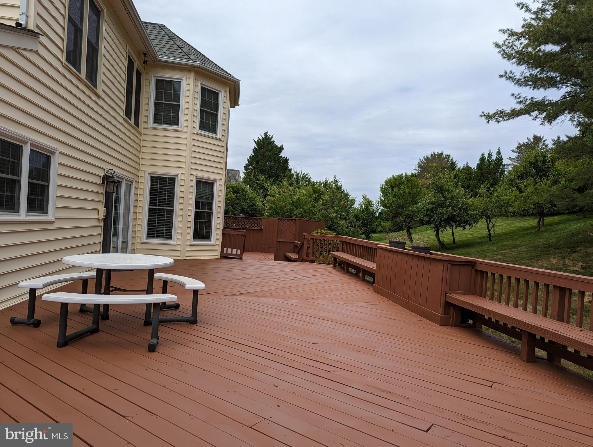 9706 Middleton Ridge Road Vienna, VA 22182 - Photo 17 of 17 a view of a roof deck with wooden floor and seating space