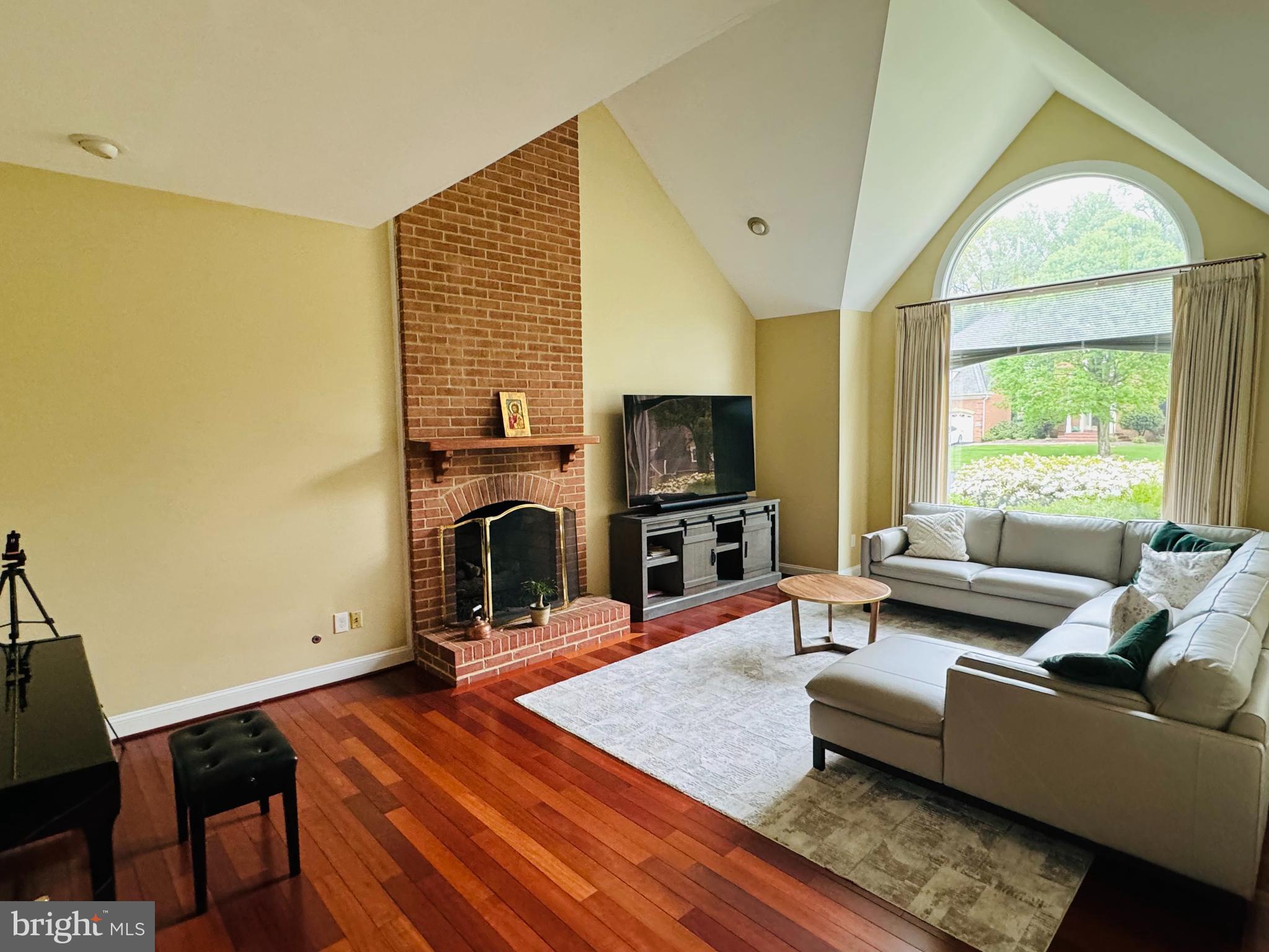9706 Middleton Ridge Road Vienna, VA 22182 - Photo 3 of 17 a living room with fireplace furniture and a flat screen tv