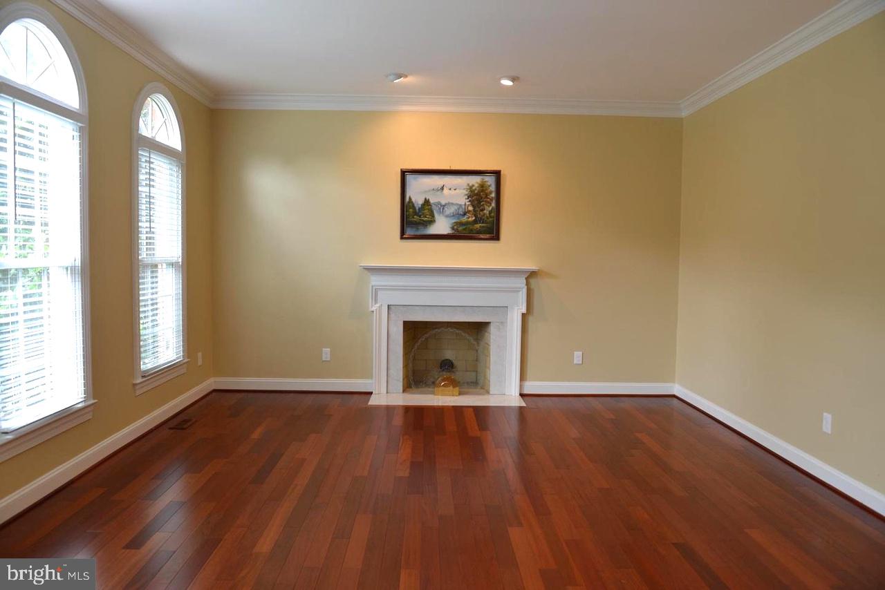 9706 Middleton Ridge Road Vienna, VA 22182 - Photo 5 of 17 a view of an empty room with a window and wooden floor