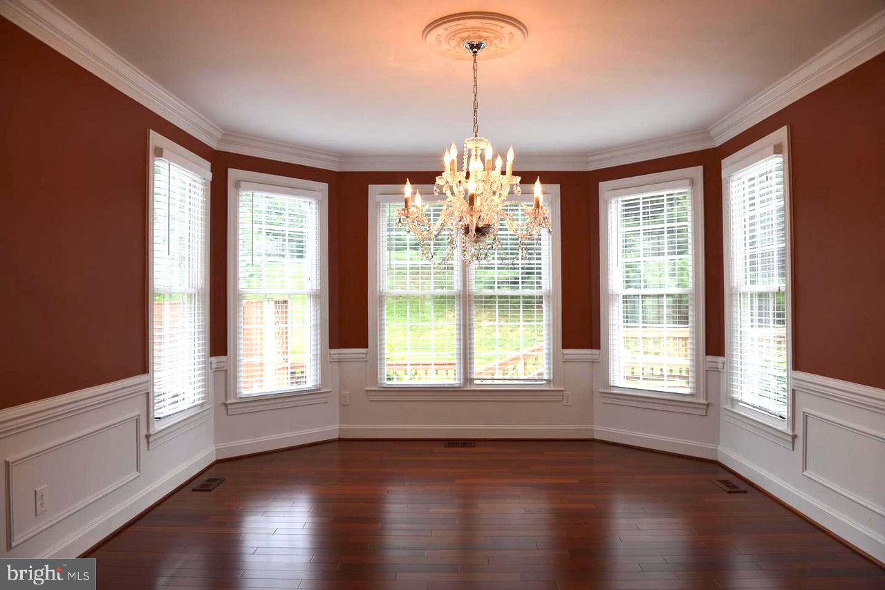 9706 Middleton Ridge Road Vienna, VA 22182 - Photo 7 of 17 a view of an empty room with wooden floor and a window