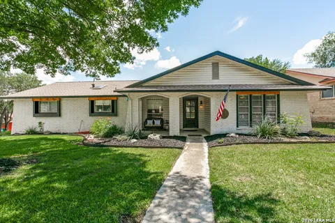 a front view of a house with a yard and porch