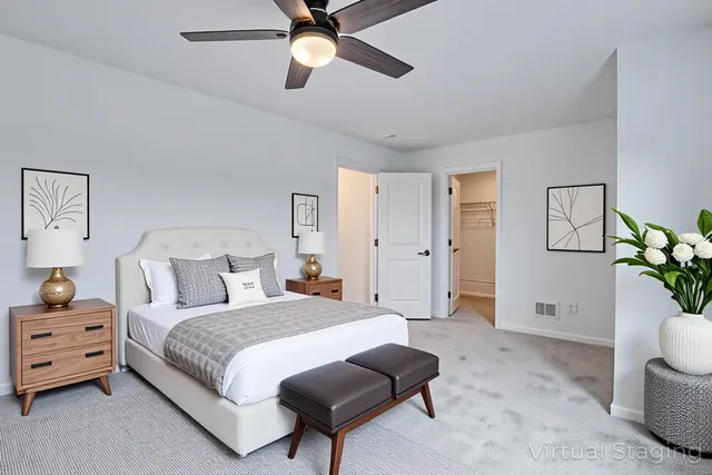 a spacious bedroom with a bed and a chandelier