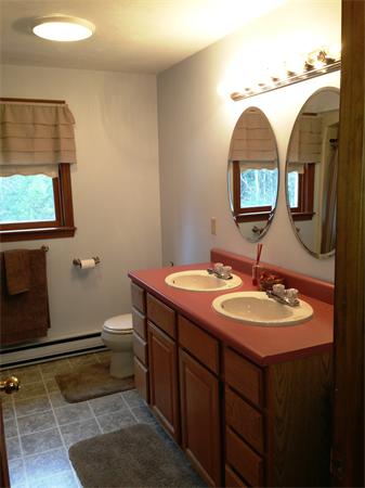 222 Hunt Road Oakham, MA 01068 - Photo 23 of 30 a bathroom with a toilet sink and mirror