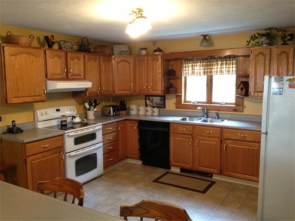 222 Hunt Road Oakham, MA 01068 - Photo 4 of 30 a kitchen with a sink stove and cabinets