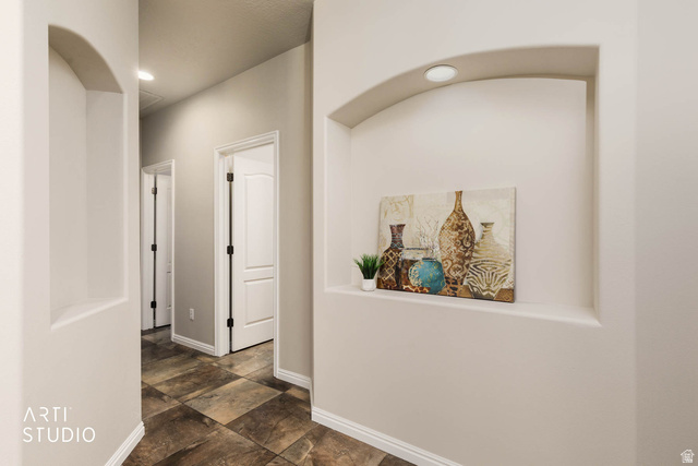 2158 Balboa Way St. George, UT 84770 - Photo 22 of 40 Hallway with recessed lighting and dark stone finish floors