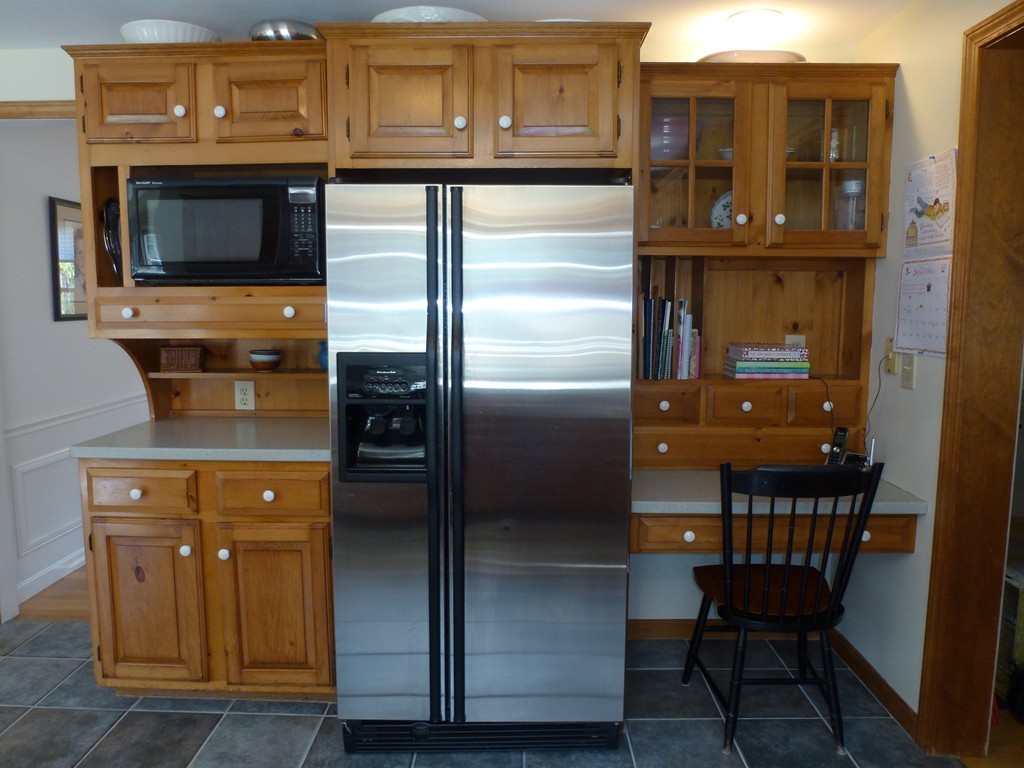82 Keyes Road Westford, MA 01886 - Photo 8 of 29 a kitchen with a refrigerator and cabinets