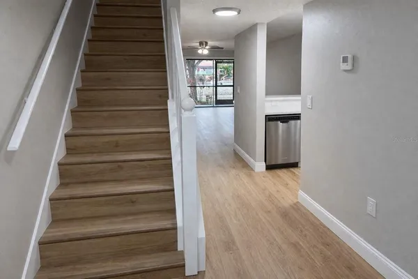 a view of an entryway with wooden floor