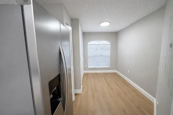 an empty room with wooden floor and a window