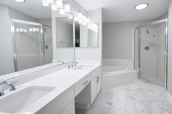 a bathroom with a tub a sink shower and mirror